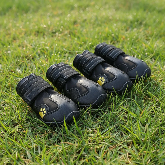 Set of black pet boots with yellow paw prints on a white background